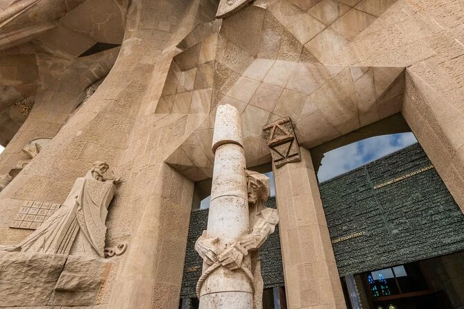 The Passion facade with the number grid of the magic square beside carved figures and a stone column